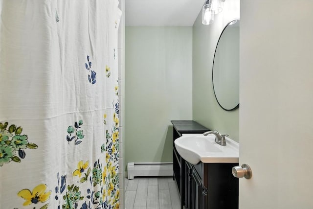 683 Rogers Ave, West Springfield, MA 01089 - bathroom with a baseboard radiator, vanity, and a shower with curtain