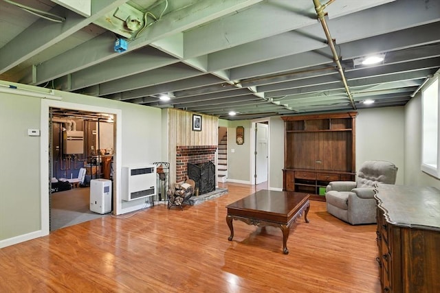683 Rogers Ave, West Springfield, MA 01089 - living area featuring heating unit, a fireplace, and light wood-style floors