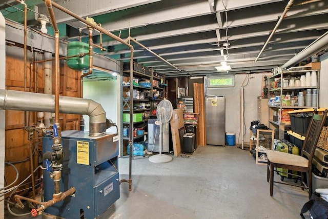 683 Rogers Ave, West Springfield, MA 01089 - basement with freestanding refrigerator and a heating unit