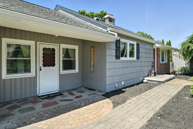 683 Rogers Ave, West Springfield, MA 01089 - doorway to property featuring a chimney and roof with shingles