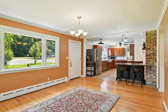 683 Rogers Ave, West Springfield, MA 01089 - kitchen with stainless steel appliances, a baseboard radiator, ornamental molding, light wood-style floors, and brown cabinets