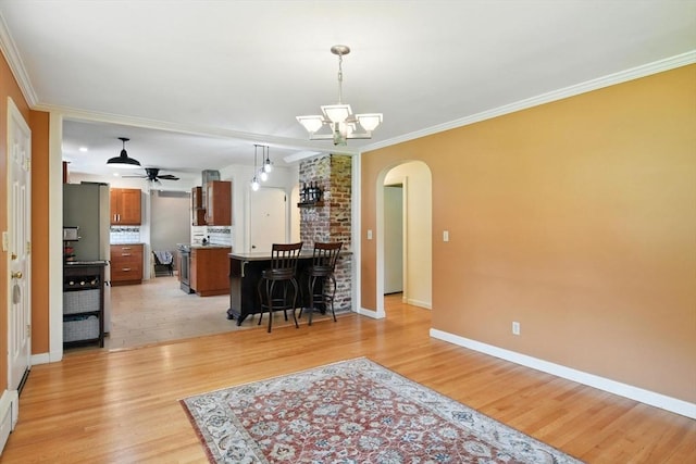 683 Rogers Ave, West Springfield, MA 01089 - kitchen with arched walkways, brown cabinetry, ceiling fan, light wood finished floors, and ornamental molding