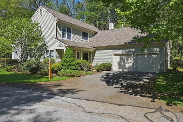 7 Alder Way Unit 7, Bedford, MA 01730 - view of front of home with asphalt driveway, a chimney, a garage, and roof with shingles