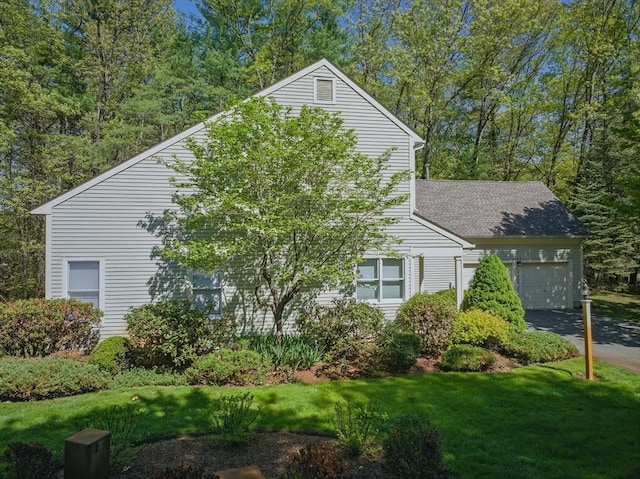 7 Alder Way Unit 7, Bedford, MA 01730 - view of property exterior featuring a garage, a lawn, and driveway