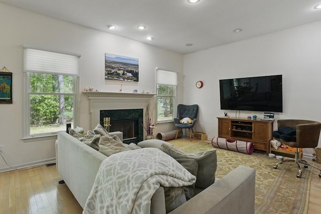 7 Alder Way Unit 7, Bedford, MA 01730 - living room featuring plenty of natural light, light wood-style flooring, a glass covered fireplace, and recessed lighting
