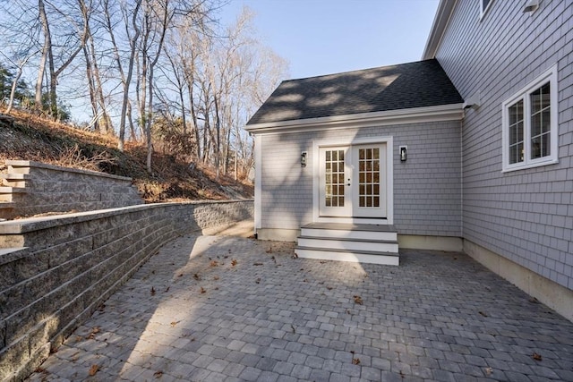 view of exterior entry with a patio area