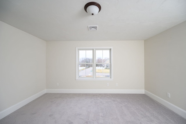 spare room with light carpet