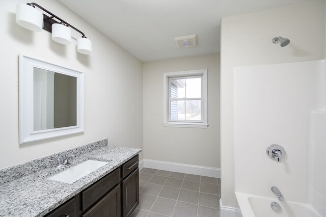 bathroom with tub / shower combination, tile patterned flooring, and vanity