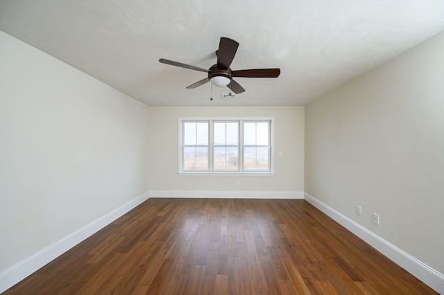 unfurnished room with ceiling fan, dark hardwood / wood-style floors, and a textured ceiling