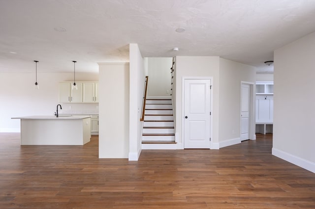 stairs with sink and hardwood / wood-style floors