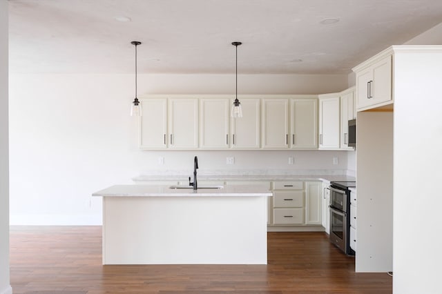 kitchen with pendant lighting, a center island with sink, appliances with stainless steel finishes, and sink