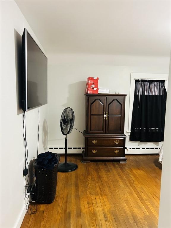 miscellaneous room featuring hardwood / wood-style floors and baseboard heating