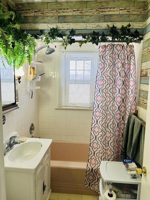 bathroom with vanity, tile patterned floors, and shower / bathtub combination with curtain