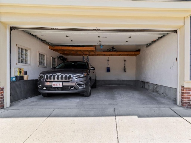 garage featuring concrete driveway