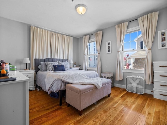 bedroom featuring light wood-type flooring and baseboards