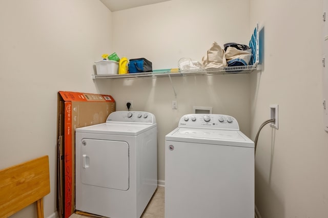 laundry area featuring separate washer and dryer and light tile patterned flooring