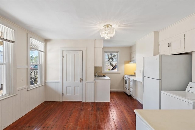 301 S Main, Haverhill, MA 01835 - kitchen featuring washer / clothes dryer, a sink, a wainscoted wall, white appliances, and dark wood-type flooring