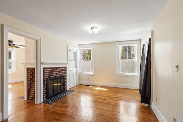 301 S Main, Haverhill, MA 01835 - unfurnished living room with baseboards, a fireplace, and light wood-type flooring