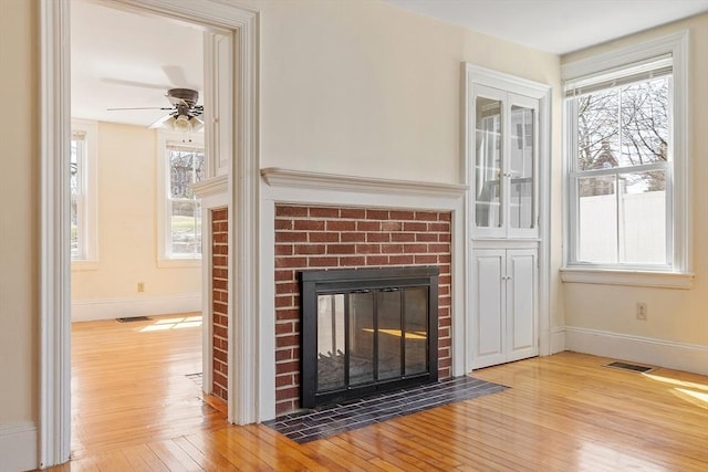 301 S Main, Haverhill, MA 01835 - details featuring a brick fireplace, baseboards, visible vents, and wood finished floors