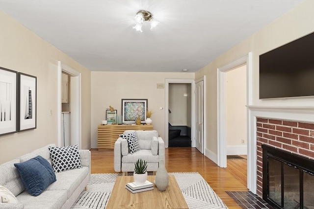 301 S Main, Haverhill, MA 01835 - living area featuring a brick fireplace and wood finished floors