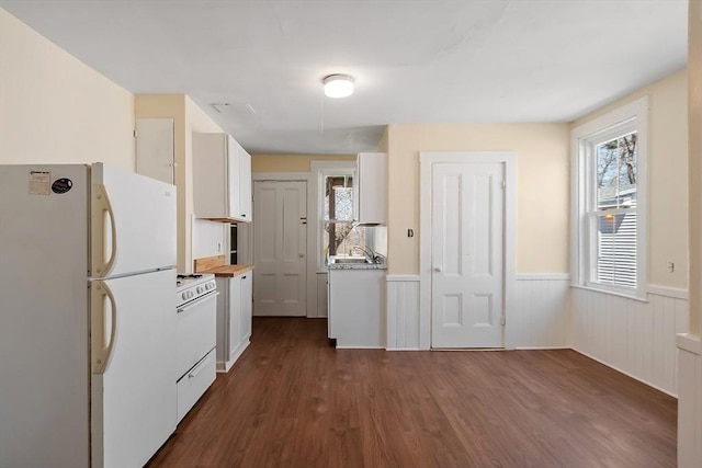 301 S Main, Haverhill, MA 01835 - kitchen with dark wood-style flooring, a sink, a wainscoted wall, white appliances, and white cabinetry
