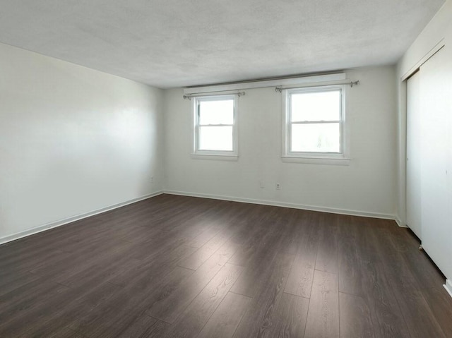 empty room featuring dark hardwood / wood-style flooring