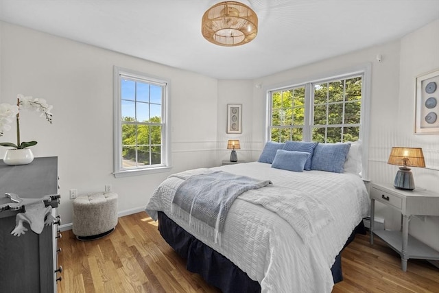 1137 Ferry St, Marshfield, MA 02050 - bedroom with multiple windows, wood finished floors, and baseboards