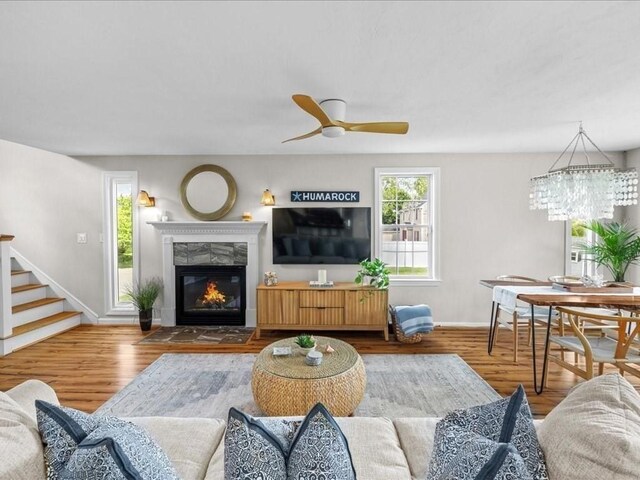 1137 Ferry St, Marshfield, MA 02050 - living room featuring baseboards, wood finished floors, a high end fireplace, ceiling fan, and stairway