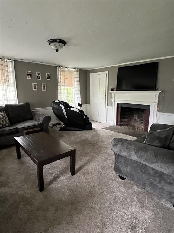 34 Old Bernardston Rd, Northfield, MA 01360 - carpeted living room with a fireplace and wainscoting