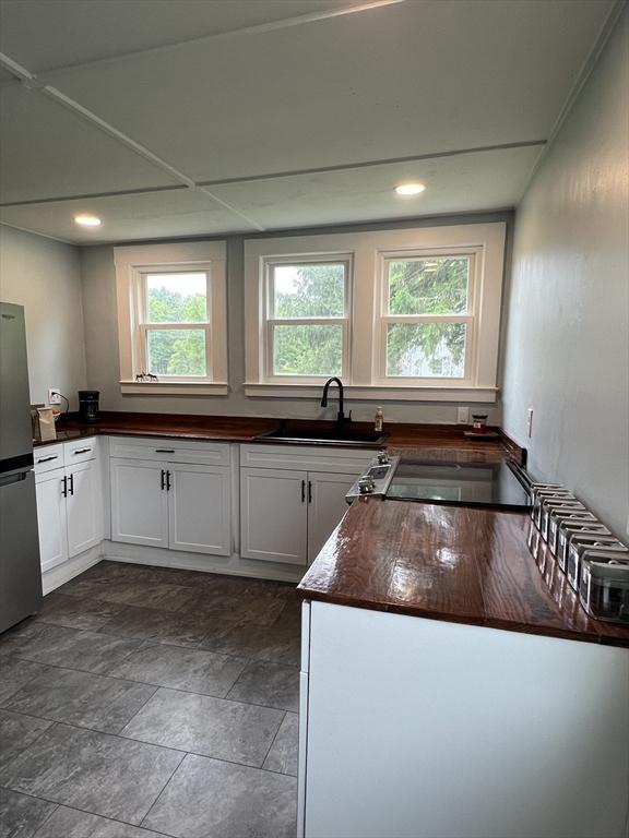 34 Old Bernardston Rd, Northfield, MA 01360 - kitchen with a sink, freestanding refrigerator, dark countertops, white cabinets, and recessed lighting