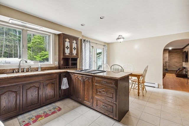 2 Orchard St, Berkley, MA 02779 - kitchen featuring a sink, arched walkways, light tile patterned flooring, a peninsula, and light stone counters