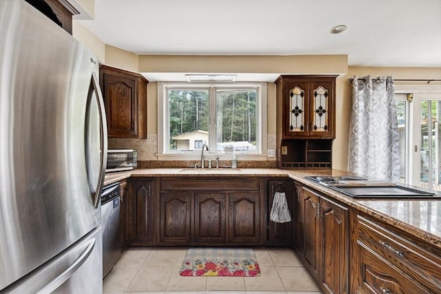 2 Orchard St, Berkley, MA 02779 - kitchen with appliances with stainless steel finishes, a sink, light tile patterned flooring, backsplash, and light stone countertops