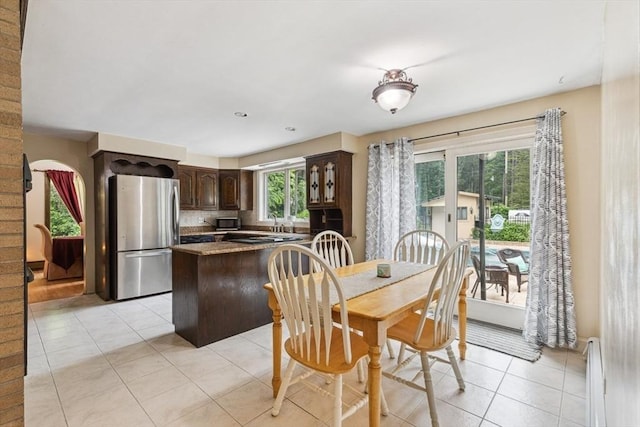 2 Orchard St, Berkley, MA 02779 - dining room with light tile patterned floors and a baseboard radiator