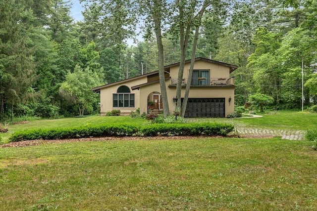 2 Orchard St, Berkley, MA 02779 - view of front of home with stucco siding, a garage, a balcony, and a front lawn