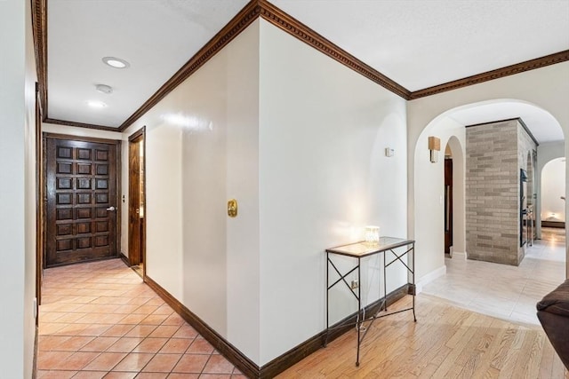 2 Orchard St, Berkley, MA 02779 - corridor featuring arched walkways, ornamental molding, baseboards, and light tile patterned flooring