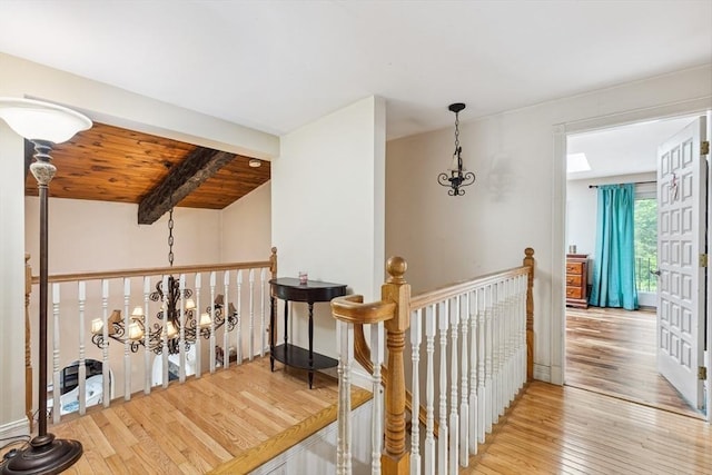 2 Orchard St, Berkley, MA 02779 - hallway with hardwood / wood-style floors, an upstairs landing, a chandelier, and wooden ceiling with exposed beams