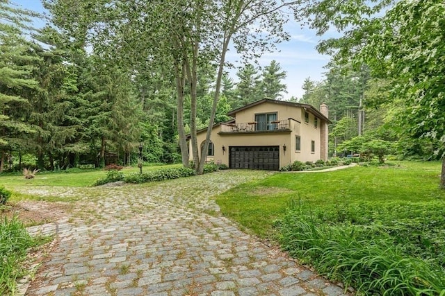 2 Orchard St, Berkley, MA 02779 - view of front facade featuring a balcony, a chimney, a garage, decorative driveway, and a front yard