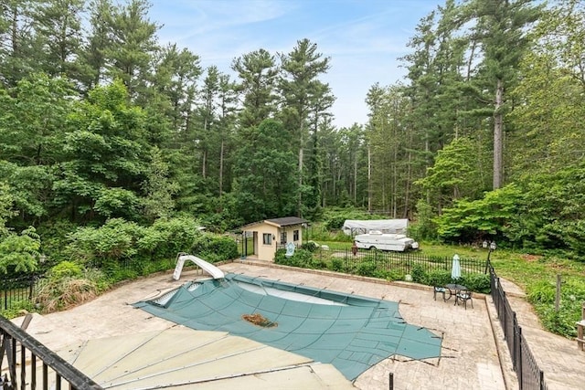 2 Orchard St, Berkley, MA 02779 - view of pool featuring a water slide, a patio area, an outdoor structure, and a forest view