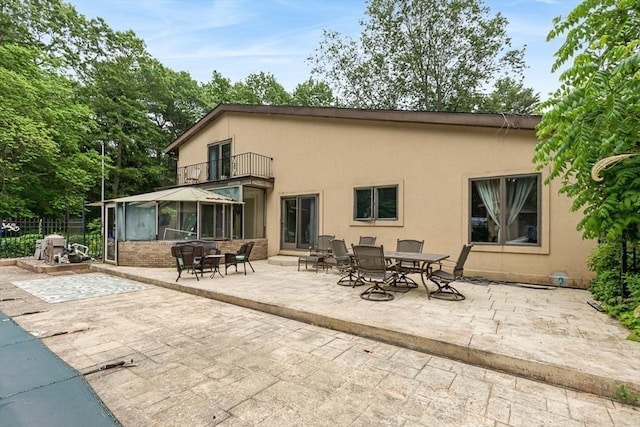 2 Orchard St, Berkley, MA 02779 - rear view of house with a balcony, a patio area, outdoor dining space, and stucco siding