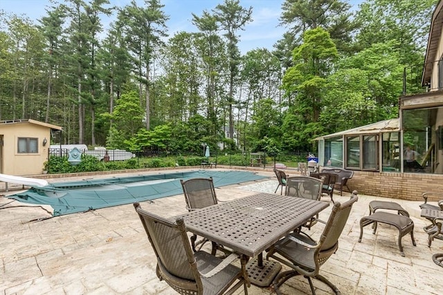 2 Orchard St, Berkley, MA 02779 - view of pool with a patio, outdoor dining area, view of wooded area, and a sunroom