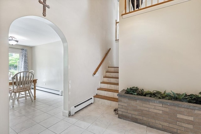 2 Orchard St, Berkley, MA 02779 - staircase with a baseboard radiator, arched walkways, and tile patterned flooring
