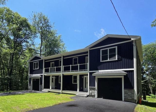 438 Granite St, Worcester, MA 01604 - multi unit property with a balcony, stone siding, a garage, a front lawn, and a porch