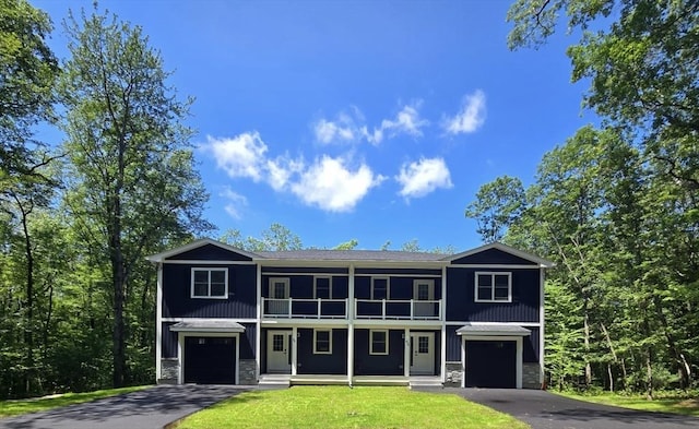 438 Granite St, Worcester, MA 01604 - view of front of home featuring a balcony, stone siding, a garage, asphalt driveway, and a front yard
