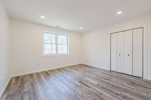 438 Granite St, Worcester, MA 01604 - unfurnished bedroom featuring wood finished floors, recessed lighting, and a closet
