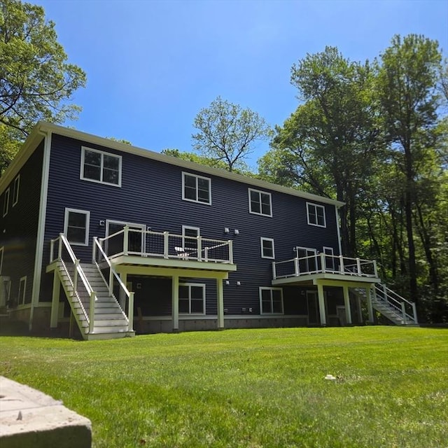 438 Granite St, Worcester, MA 01604 - back of property with stairway, a wooden deck, and a lawn