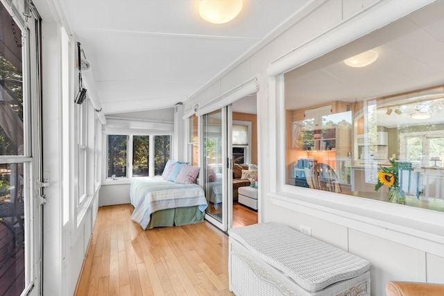 bedroom with lofted ceiling and wood-type flooring