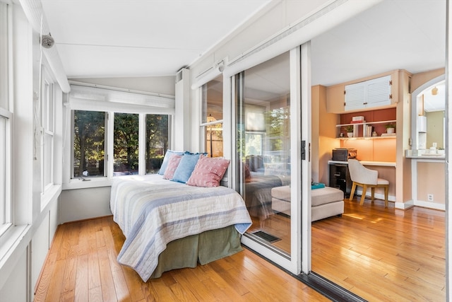 bedroom featuring lofted ceiling and light hardwood / wood-style floors