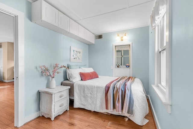 bedroom with light wood-type flooring