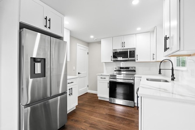 11 Bishop Rd Unit 11, Quincy, MA 02170 - kitchen with stainless steel appliances, a sink, dark wood-style floors, recessed lighting, and white cabinets
