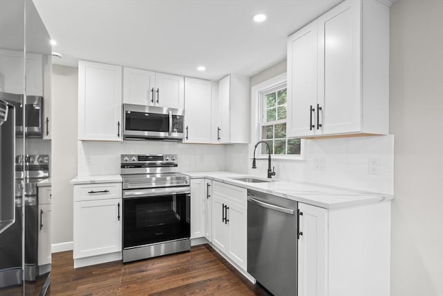 11 Bishop Rd Unit 11, Quincy, MA 02170 - kitchen featuring appliances with stainless steel finishes, a sink, dark wood-style flooring, recessed lighting, and decorative backsplash